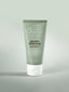 Tube of emerge Scientific Organics Blue Poppy Enzyme Polish on a green background